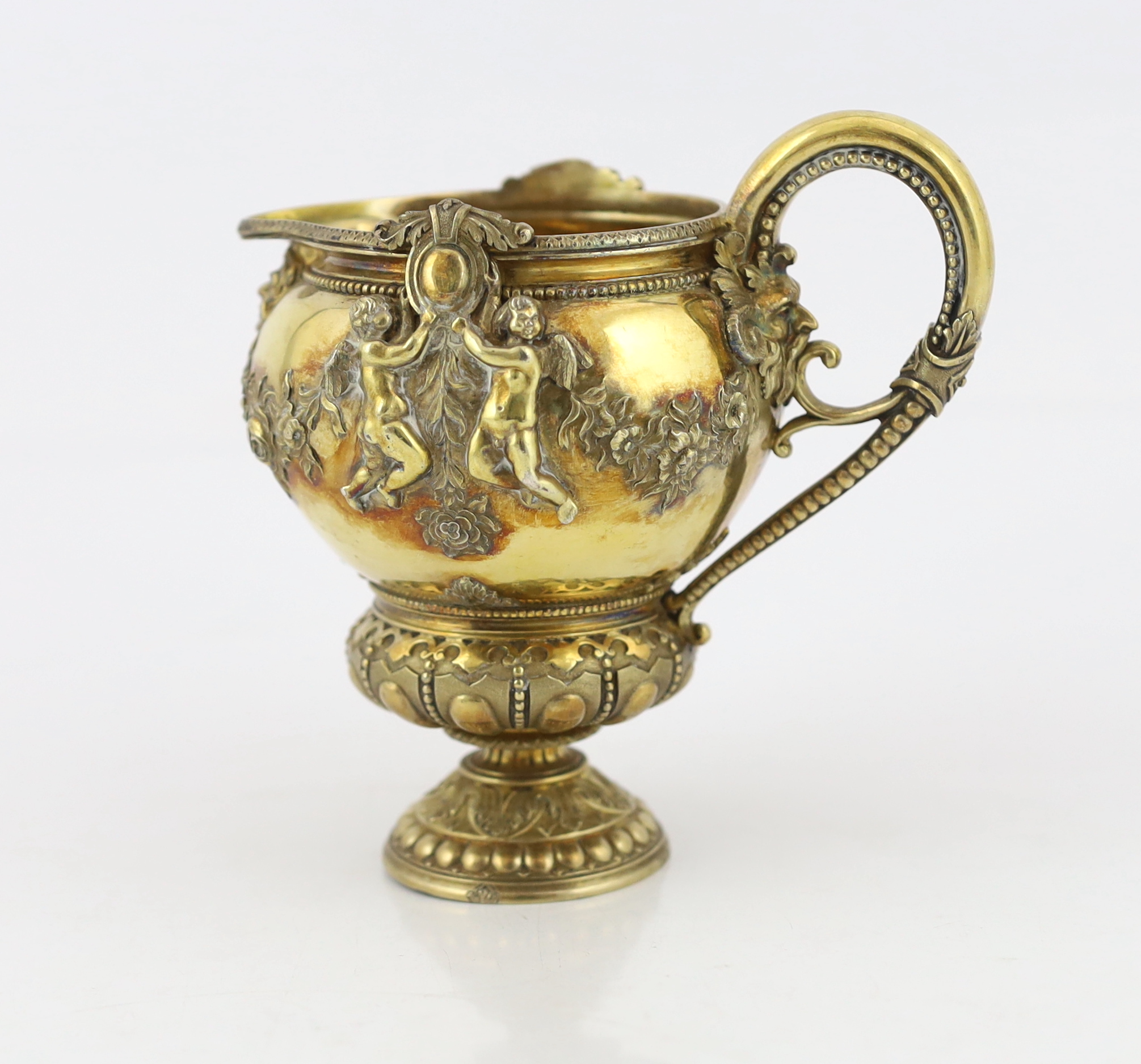 An early Victorian ornate silver gilt cream jug, by George Ivory